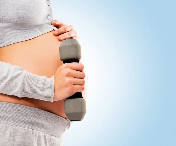 Pregnant woman with dumbbells — Stock Photo, Image