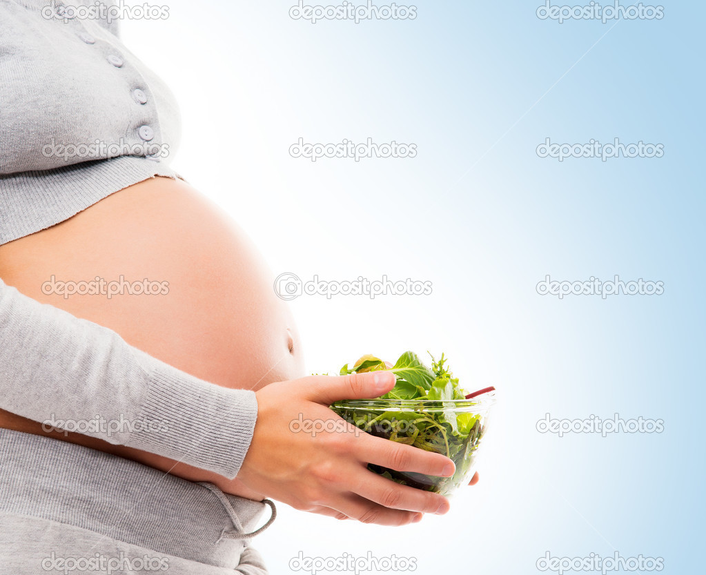 Pregnant woman with fresh green salad