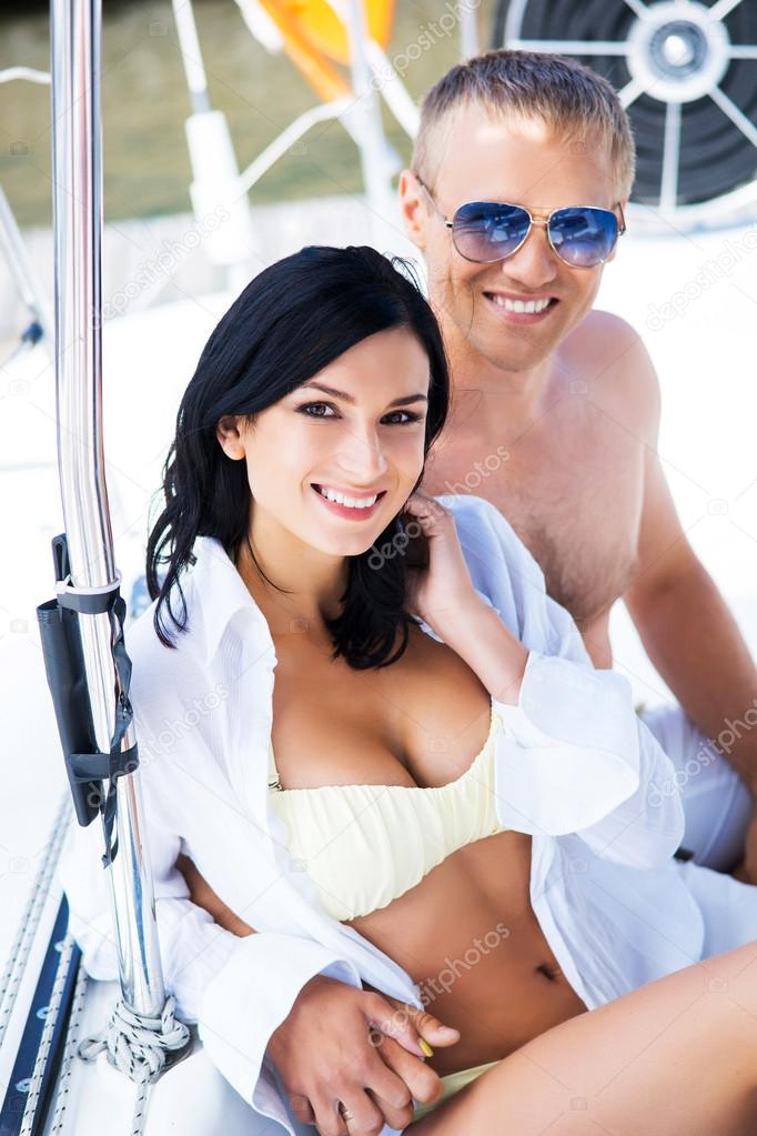 Couple relaxing on sailing boat