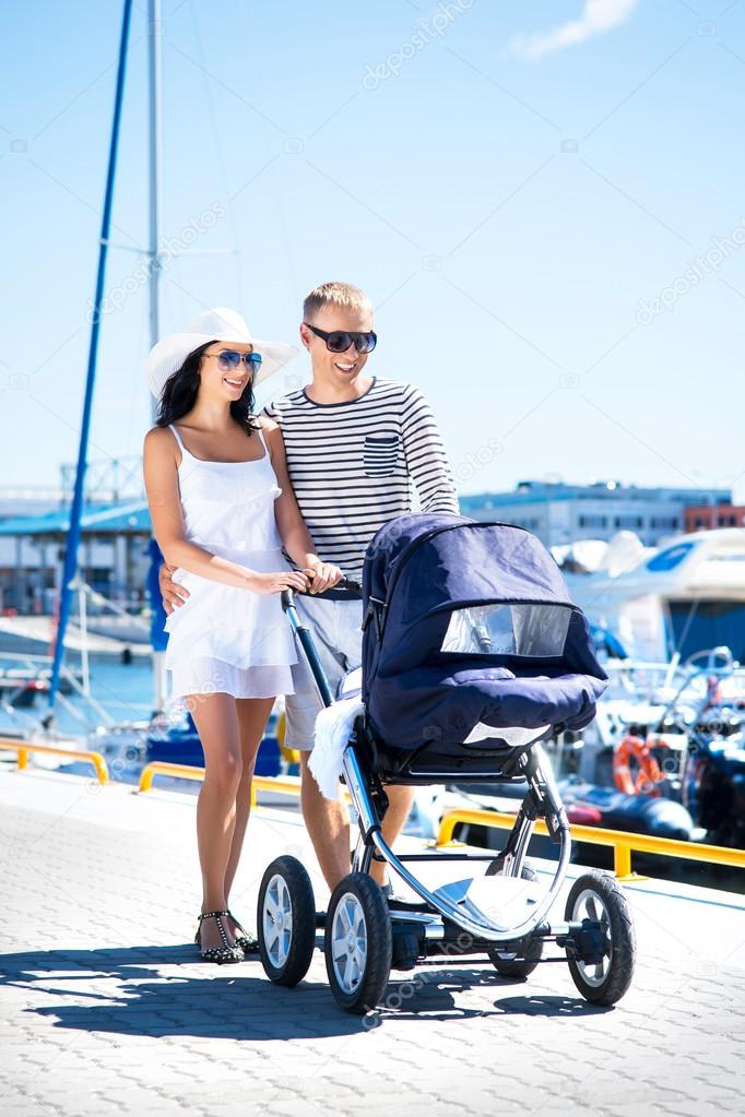 Couple walking with baby pram