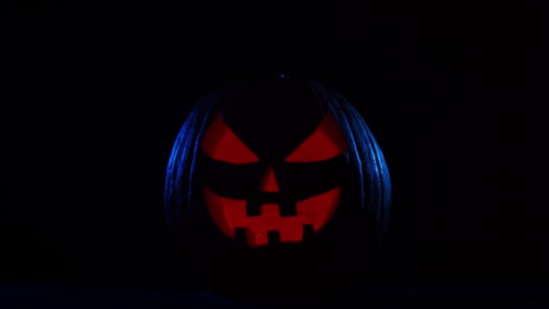 Scary laughing pumpkin on a dark background. Halloween, witchcraft and magic. — Stock Video