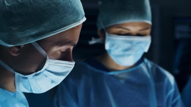 Многорасовая команда профессиональных медицинских хирургов проводит хирургическую операцию в современной больнице. Врачи работают, чтобы спасти пациента. Медицина, здоровье, кардиология и трансплантация. — стоковое видео