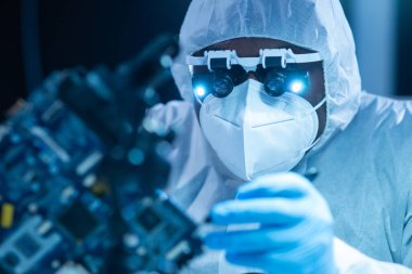 Afrikalı-Amerikalı bilim adamı, mikro elektronik ve işlemcilerin araştırılması ve geliştirilmesi için modern bir bilim laboratuvarında çalışıyor. Üretim işçisi bilgisayar teknolojisi ve ekipmanı kullanıyor.