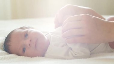 Yakın zamanda doğan bir bebeğin yakın plan portresi. Yeni doğmuş erkek bebek evde. Pencere ışığı.