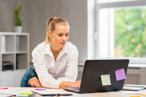 Lugar de trabajo del trabajador independiente o de una estudiante en la oficina del hogar. Mujer joven trabaja usando la computadora y otros dispositivos. Concepto de trabajo remoto. —  Fotos de Stock