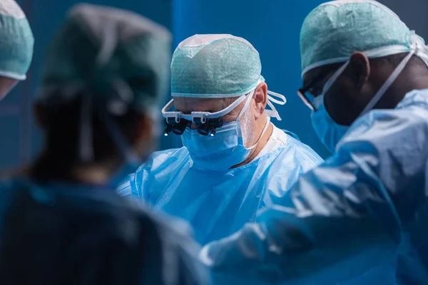 プロの外科医の多人種チームは、現代の病院で外科手術を行います。医者は患者を救うために働いている。医学、健康、心臓学、移植. — ストック写真