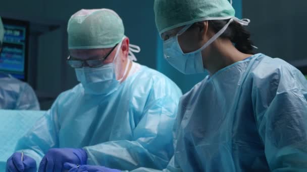 専門医のチームは、現代の病院で外科手術を行います。医者は患者を救うために働いている。医学、健康、心臓学、移植の概念. — ストック動画