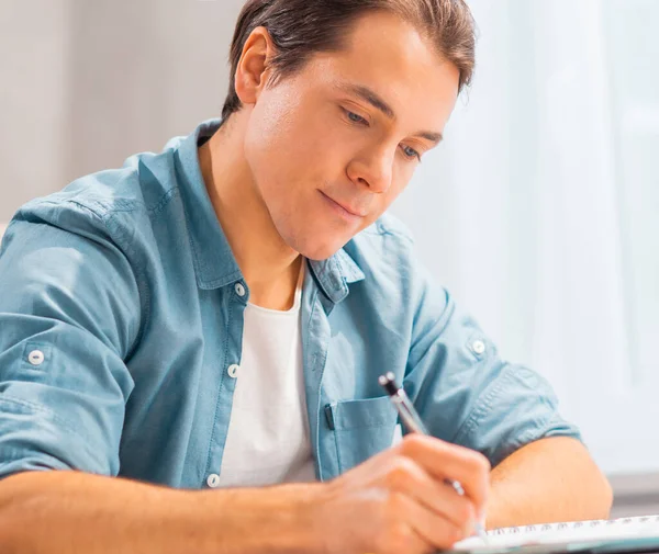 Young man works at home. Freelancer, remote worker or student workplace. Distant work concept. — Stock Photo, Image