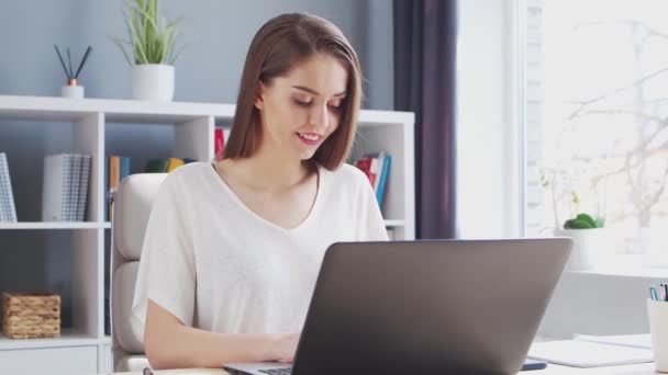 Junge Frau arbeitet im Home Office am Computer. Arbeitsplatz der Unternehmerin, Freiberuflerin oder Studentin. Fernarbeit und Bildungskonzept. — Stockvideo