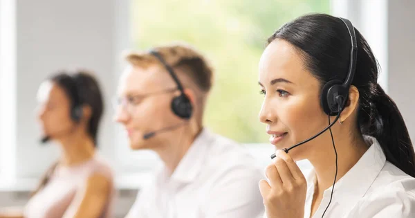 Team van professionele ondersteunend personeel werkzaam in het kantoor. Collega 's op de werkplek lossen klantproblemen op. Call center en customer support concept. — Stockfoto