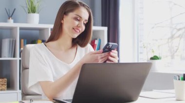 Genç Kadın İç İşleri 'nde Bilgisayar ve Smertphone kullanarak çalışıyor. Kadın Girişimci, Freelancer ya da Öğrenci 'nin işyeri. Uzaktan Çalışma ve Eğitim Konsepti.