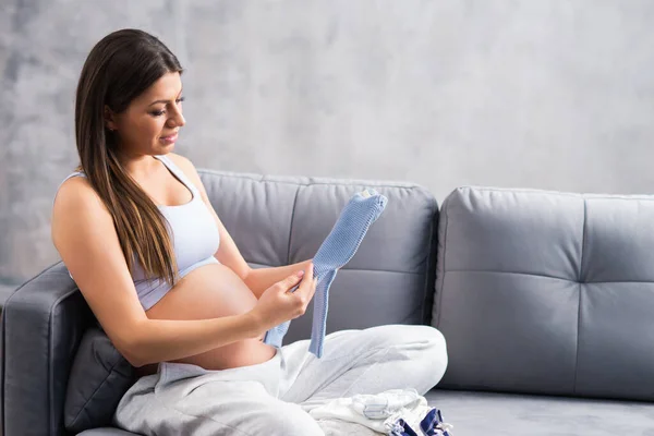 Junge schwangere Frau ruht sich zu Hause aus und erwartet ein Baby. Schwangerschaft, Mutterschaft, Gesundheitsfürsorge und Lebensstil-Konzept. — Stockfoto