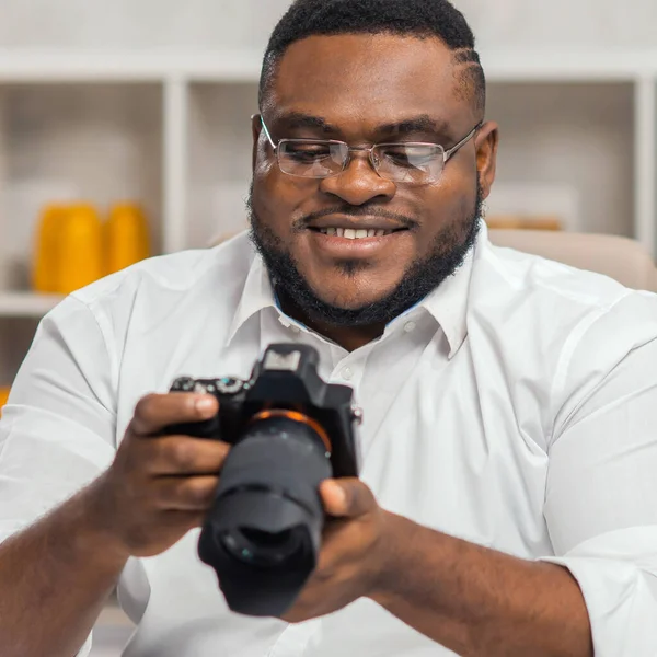 Young African-American photographer works in home office. Remote job concept. — Stock Photo, Image