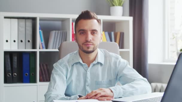 Junger Mann arbeitet, während er zu Hause vor dem Computer sitzt Der Arbeitsplatz eines Berufstätigen, Freiberuflers oder Studenten. Fernarbeit und Bildungskonzept. — Stockvideo