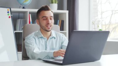 Genç Öğretmen evde bilgisayarın önünde otururken çevrimiçi ders veriyor. Okul Dersleri Öğretmeni 'nin İş Yeri. Uzaktan Eğitim ve Öğrenim Konsepti.