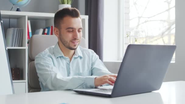 Young Teacher makes an Online Lesson while Sitting in Front of Computer at Home. The Workplace of the Tutor for School Lessons. Distant Study and Education Concept. — Αρχείο Βίντεο
