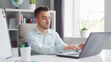Young Teacher makes an Online Lesson while Sitting in Front of Computer at Home. The Workplace of the Professional Tutor for School Lessons. Distant Study and Education Concept.