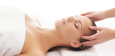 Young, beautiful and healthy woman in spa salon. Traditional massage therapy and skin care treatments.