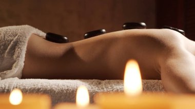 Young, healthy and beautiful woman gets massage therapy in the spa salon. Concept of healthy lifestyle and body care.