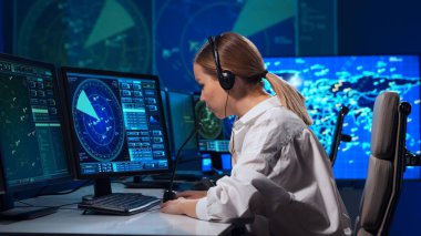 Workplace of the air traffic controllers in the control tower. Team of professional aircraft control officers works using radar, computer navigation and digital maps. The concept of aviation.
