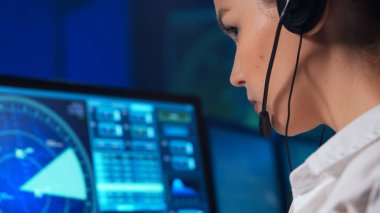 Workplace of the air traffic controllers in the control tower. Team of professional aircraft control officers works using radar, computer navigation and digital maps. The concept of aviation.