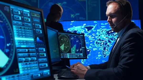 Workplace of the air traffic controllers in the control tower. Team of professional aircraft control officers works using radar, computer navigation and digital maps. The concept of aviation.