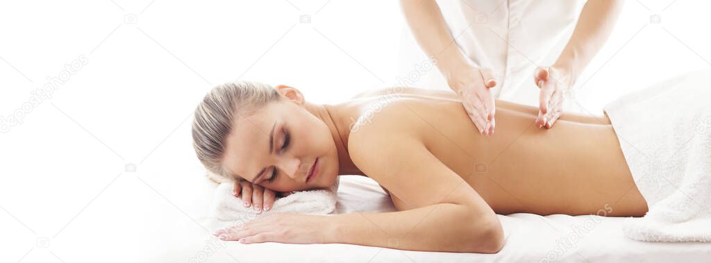 Young, beautiful and healthy woman in spa salon. Traditional massage therapy and skin care treatments. Healthcare and recreation concept.