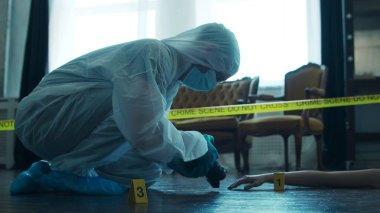 Detective Collecting Evidence in a Crime Scene. Forensic Specialists Making Expertise at Home of a Dead Person. The Concept of Homicide Investigation by Professional Police Officer.