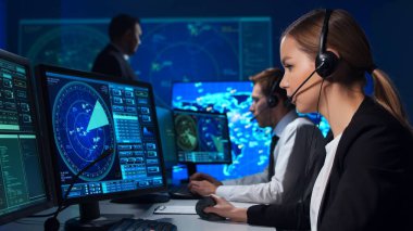 Workplace of the air traffic controllers in the control tower. Team of professional aircraft control officers works using radar, computer navigation and digital maps. The concept of aviation.