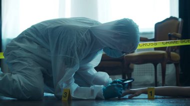 Detective Collecting Evidence in a Crime Scene. Forensic Specialists Making Expertise at Home of a Dead Person. The Concept of Homicide Investigation by Professional Police Officer.