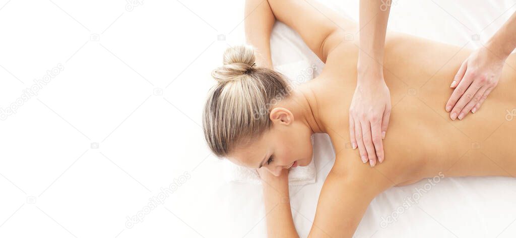 Young, beautiful and healthy woman in spa salon. Traditional massage therapy and skin care treatments. Healthcare and recreation concept.