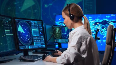Workplace of the air traffic controllers in the control tower. Team of professional aircraft control officers works using radar, computer navigation and digital maps. The concept of aviation.