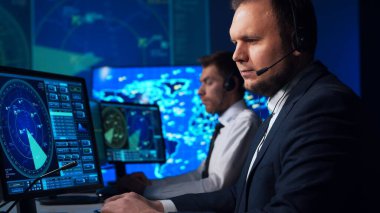Workplace of the air traffic controllers in the control tower. Team of professional aircraft control officers works using radar, computer navigation and digital maps. The concept of aviation.
