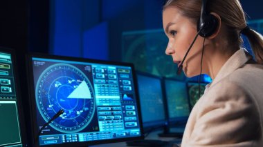 Workplace of the air traffic controllers in the control tower. Team of professional aircraft control officers works using radar, computer navigation and digital maps. The concept of aviation.
