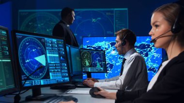 Workplace of the air traffic controllers in the control tower. Team of professional aircraft control officers works using radar, computer navigation and digital maps. The concept of aviation.