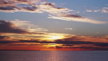 Timelapse with Sunset and Cumulus Clouds Flying High in a Beautiful Blue Sky. Sun Dawn in the Sea. Concept of Weather, Climate Change and Global Warming.