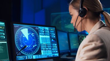 Workplace of the air traffic controllers in the control tower. Team of professional aircraft control officers works using radar, computer navigation and digital maps. The concept of aviation.
