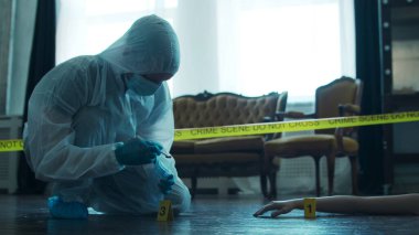 Detective Collecting Evidence in a Crime Scene. Forensic Specialists Making Expertise at Home of a Dead Person. The Concept of Homicide Investigation by Professional Police Officer.