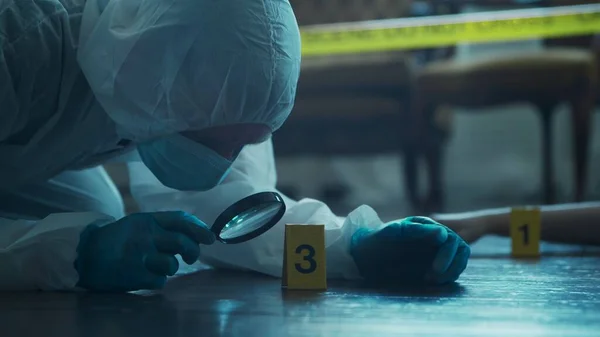 Detective Collecting Evidence in a Crime Scene. Forensic Specialists Making Expertise at Home of a Dead Person. The Concept of Homicide Investigation by Professional Police Officer.