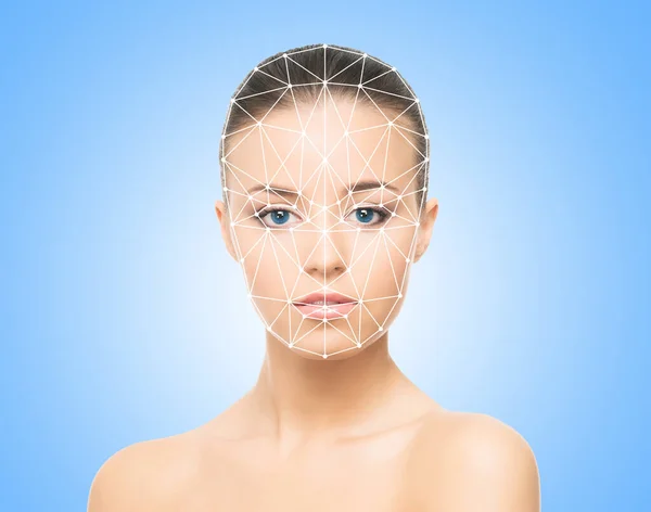 Face of a beautifyl girl with a scanning grid on her face. The concept of face id, security, facial recognition, authentication technology.