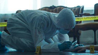 Detective Collecting Evidence in a Crime Scene. Forensic Specialists Making Expertise at Home of a Dead Person. The Concept of Homicide Investigation by Professional Police Officer.