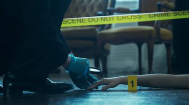 Detective Collecting Evidence in a Crime Scene. Forensic Specialists Making Expertise at Home of a Dead Person. The Concept of Homicide Investigation by Professional Police Officer.
