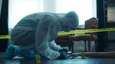 Detective Collecting Evidence in a Crime Scene. Forensic Specialists Making Expertise at Home of a Dead Person. The Concept of Homicide Investigation by Professional Police Officer.