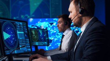 Workplace of the air traffic controllers in the control tower. Team of professional aircraft control officers works using radar, computer navigation and digital maps. The concept of aviation.