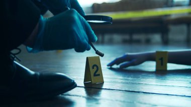 Detective Collecting Evidence in a Crime Scene. Forensic Specialists Making Expertise at Home of a Dead Person. The Concept of Homicide Investigation by Professional Police Officer.