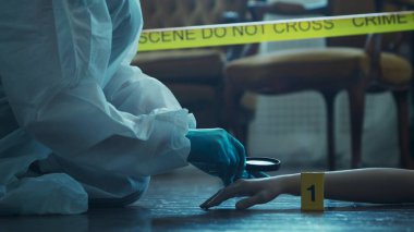 Detective Collecting Evidence in a Crime Scene. Forensic Specialists Making Expertise at Home of a Dead Person. The Concept of Homicide Investigation by Professional Police Officer.