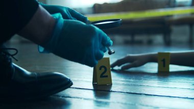 Detective Collecting Evidence in a Crime Scene. Forensic Specialists Making Expertise at Home of a Dead Person. The Concept of Homicide Investigation by Professional Police Officer.