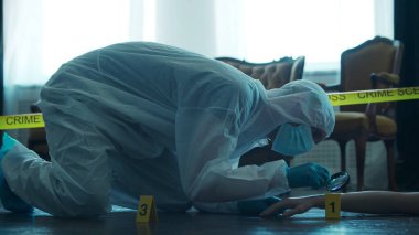 Detective Collecting Evidence in a Crime Scene. Forensic Specialists Making Expertise at Home of a Dead Person. The Concept of Homicide Investigation by Professional Police Officer.