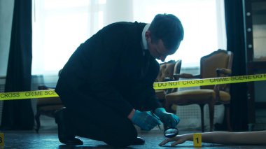 Detective Collecting Evidence in a Crime Scene. Forensic Specialists Making Expertise at Home of a Dead Person. The Concept of Homicide Investigation by Professional Police Officer.