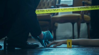 Detective Collecting Evidence in a Crime Scene. Forensic Specialists Making Expertise at Home of a Dead Person. The Concept of Homicide Investigation by Professional Police Officer.